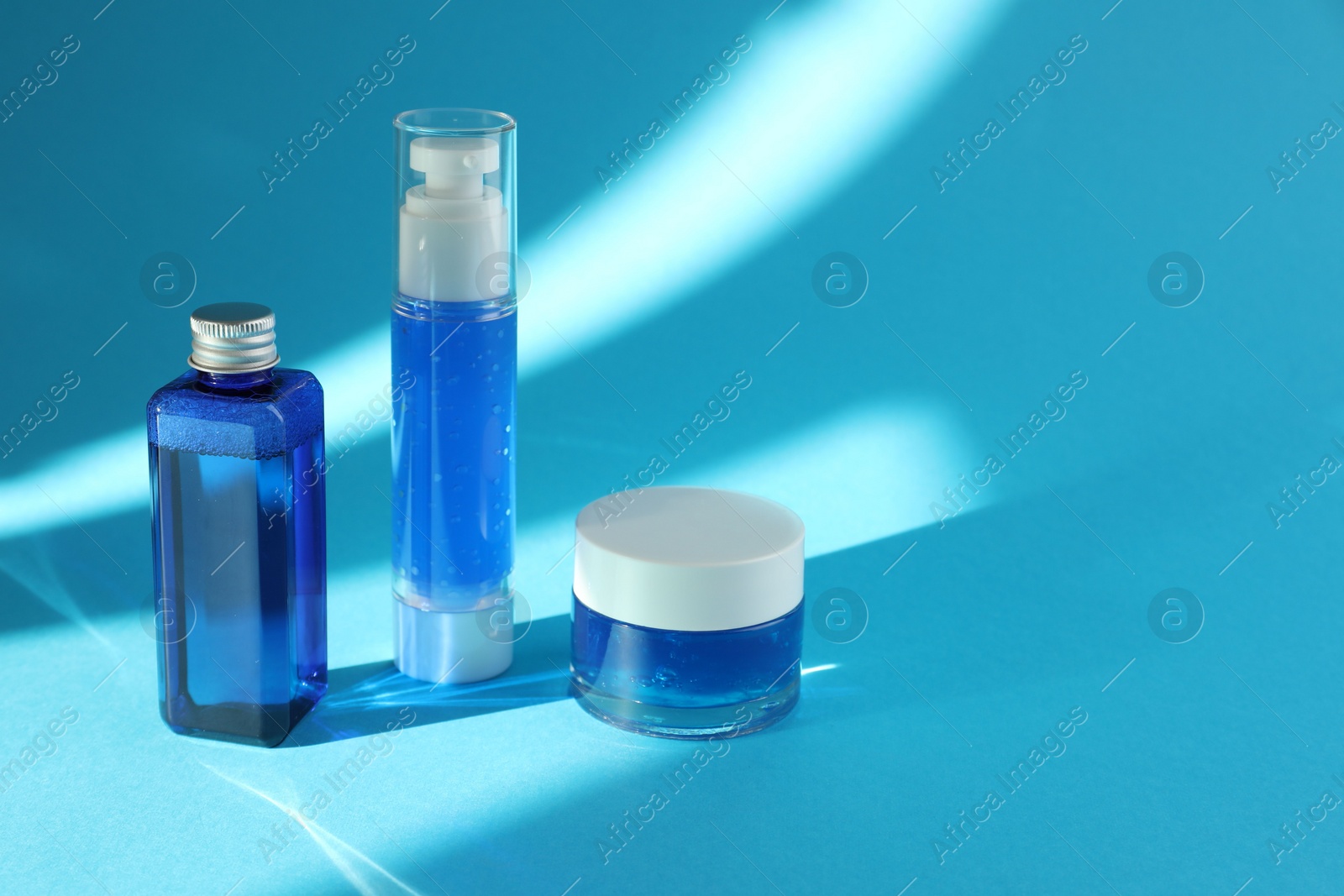 Photo of Set of luxury cosmetic products on light blue background. Space for text