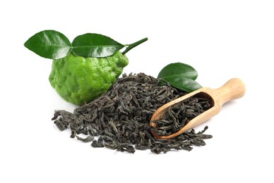 Dry bergamot tea leaves, wooden scoop and fresh fruit on white background