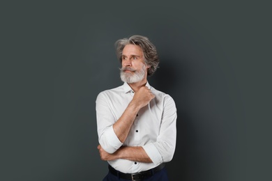 Portrait of handsome mature man on dark background