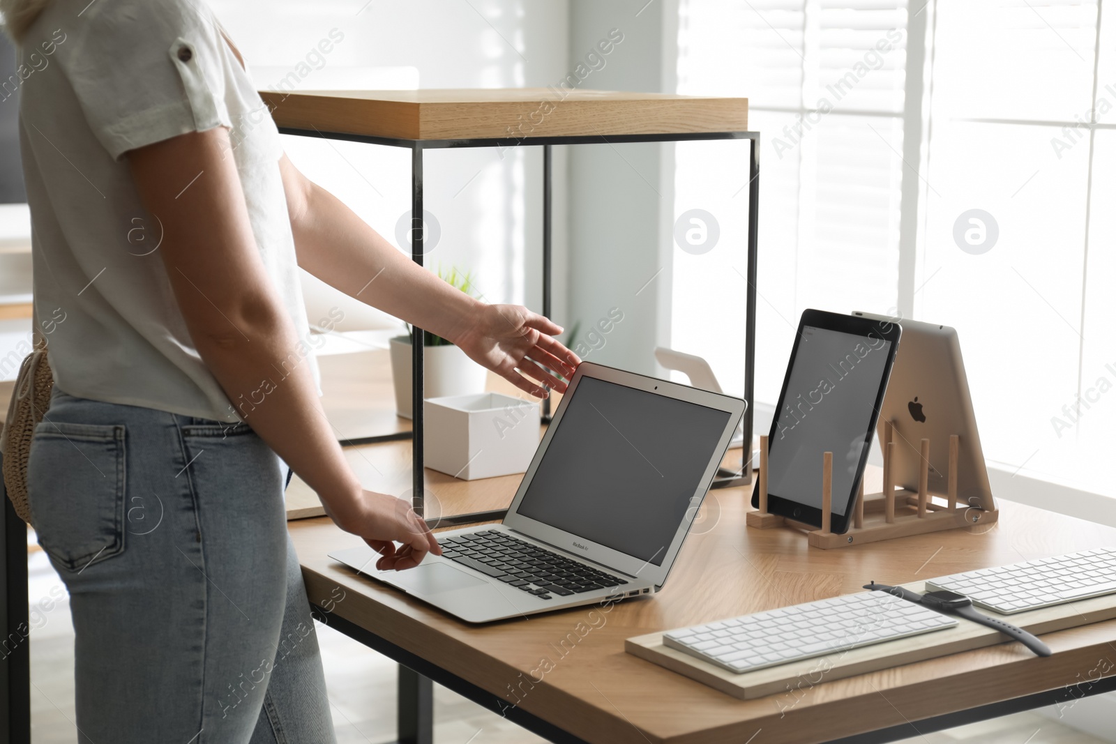 Photo of MYKOLAIV, UKRAINE - AUGUST 17, 2020: Woman choosing MacBook in Apple Store, closeup