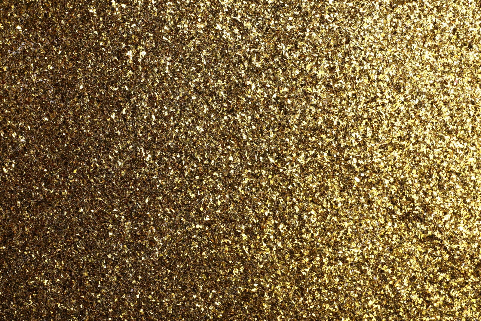 Photo of Beautiful shiny brass glitter as background, closeup