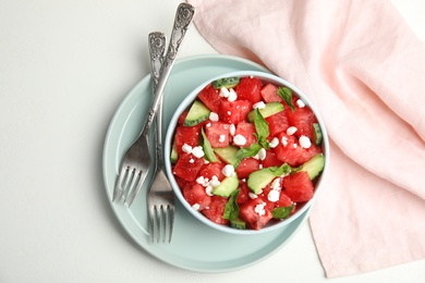 Photo of Delicious salad with watermelon, cucumber and cheese on white table, flat lay