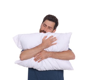 Photo of Sleepy handsome man hugging soft pillow on white background
