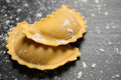 Ravioli on grey wooden table, closeup. Italian pasta