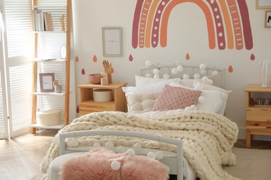 Photo of Stylish child's room interior with comfortable bed