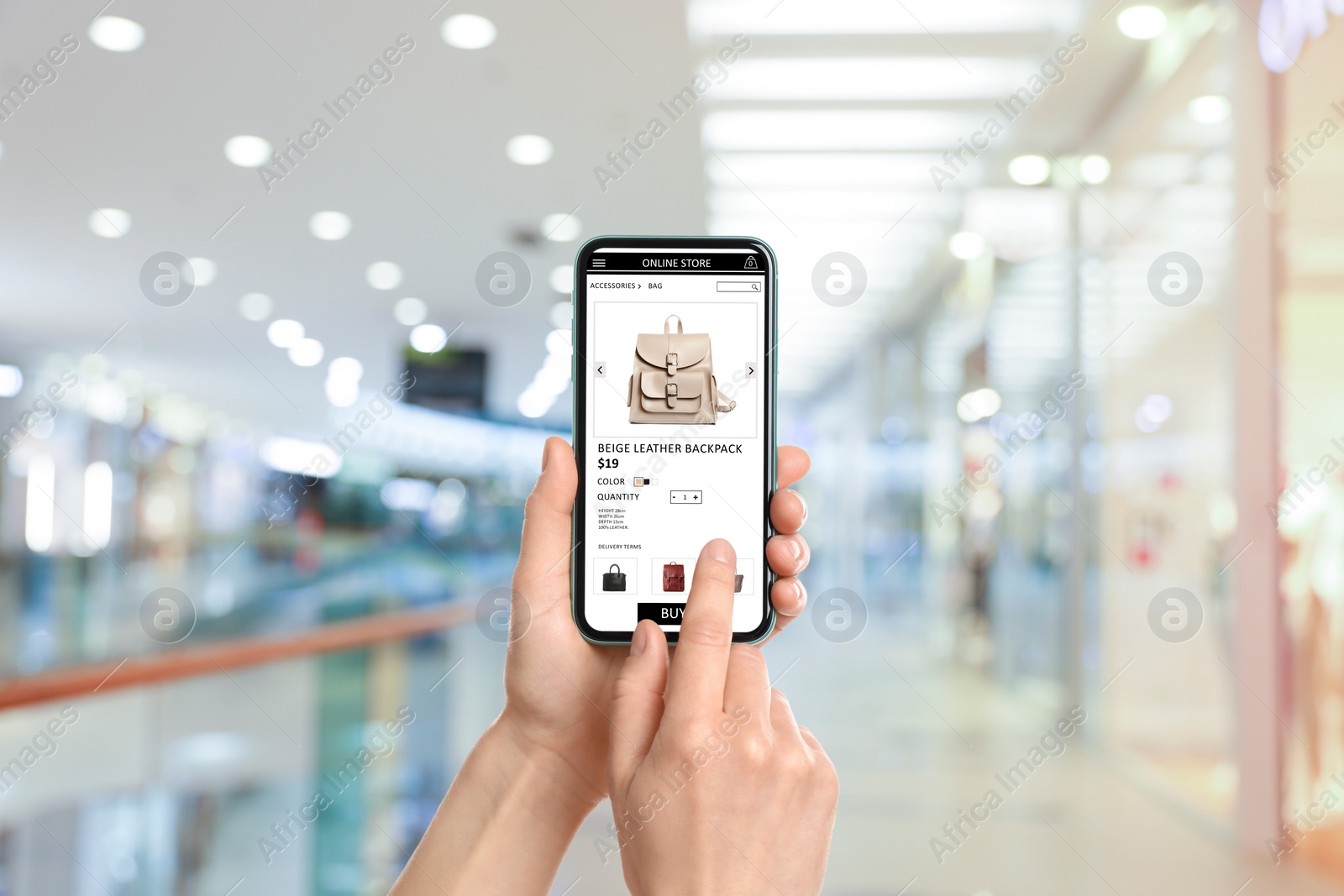 Image of Woman visiting shop to take ordered backpack indoors, closeup. Online store website on device screen