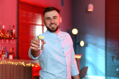 Photo of Young man with Mexican Tequila shot in bar