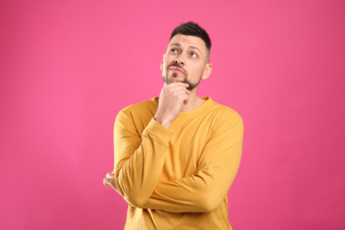 Photo of Emotional man in casual outfit on pink background