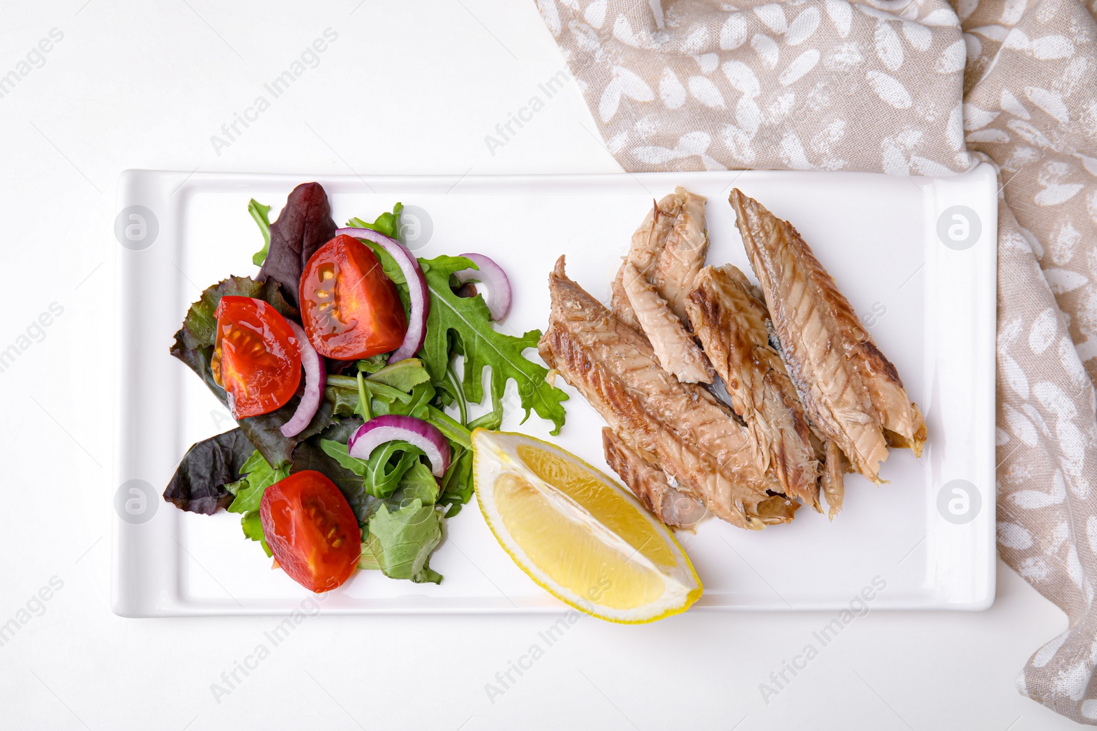 Photo of Delicious canned mackerel fillets served on white table, top view