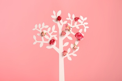 Photo of Decorative tree with flowers on color background
