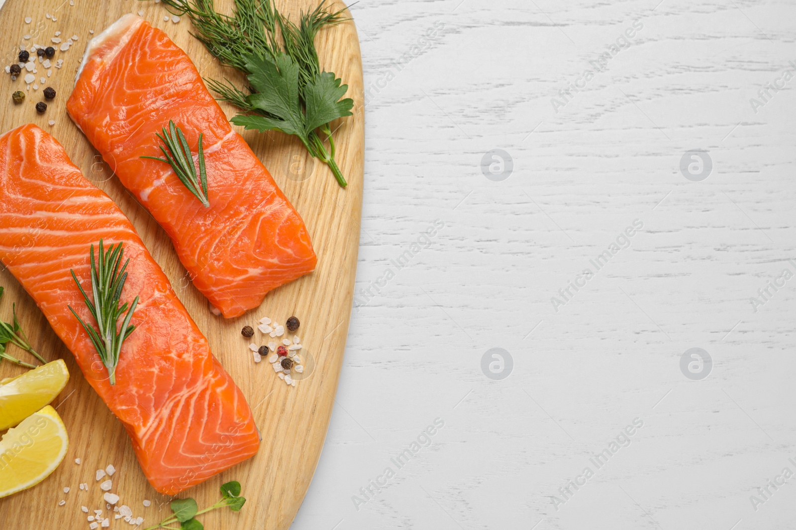 Photo of Fresh salmon and ingredients for marinade on white wooden table, top view. Space for text