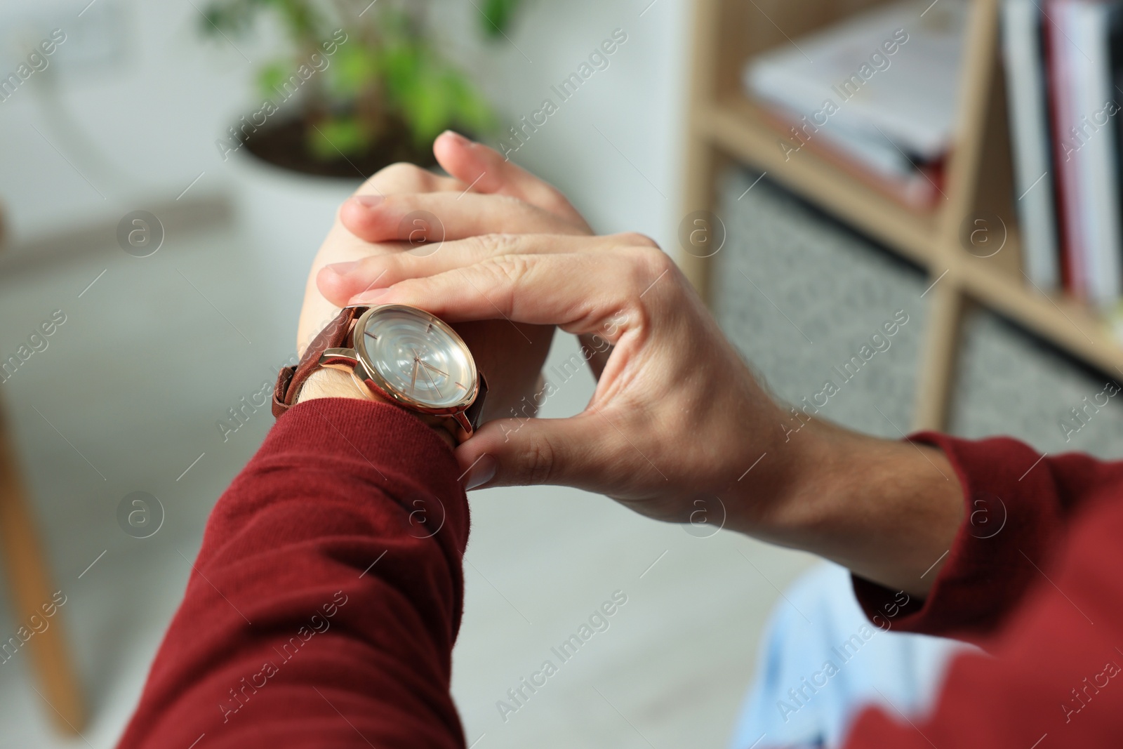 Photo of Man checking time in room, closeup. Being late