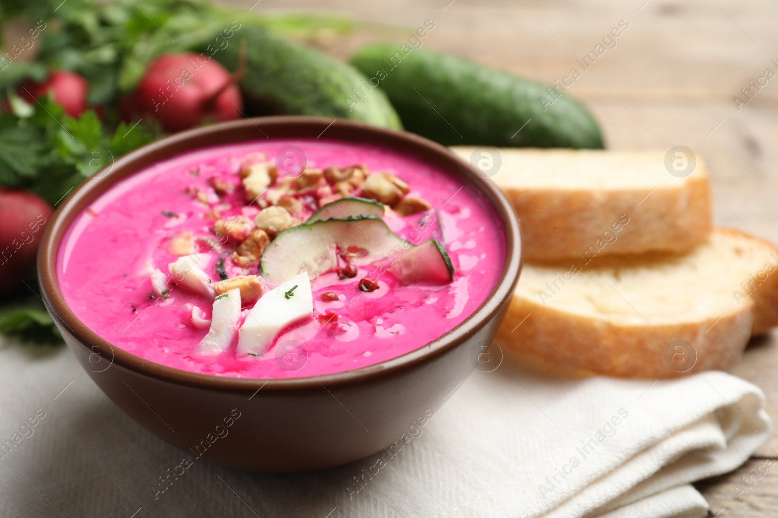 Photo of Delicious cold summer beet soup on table