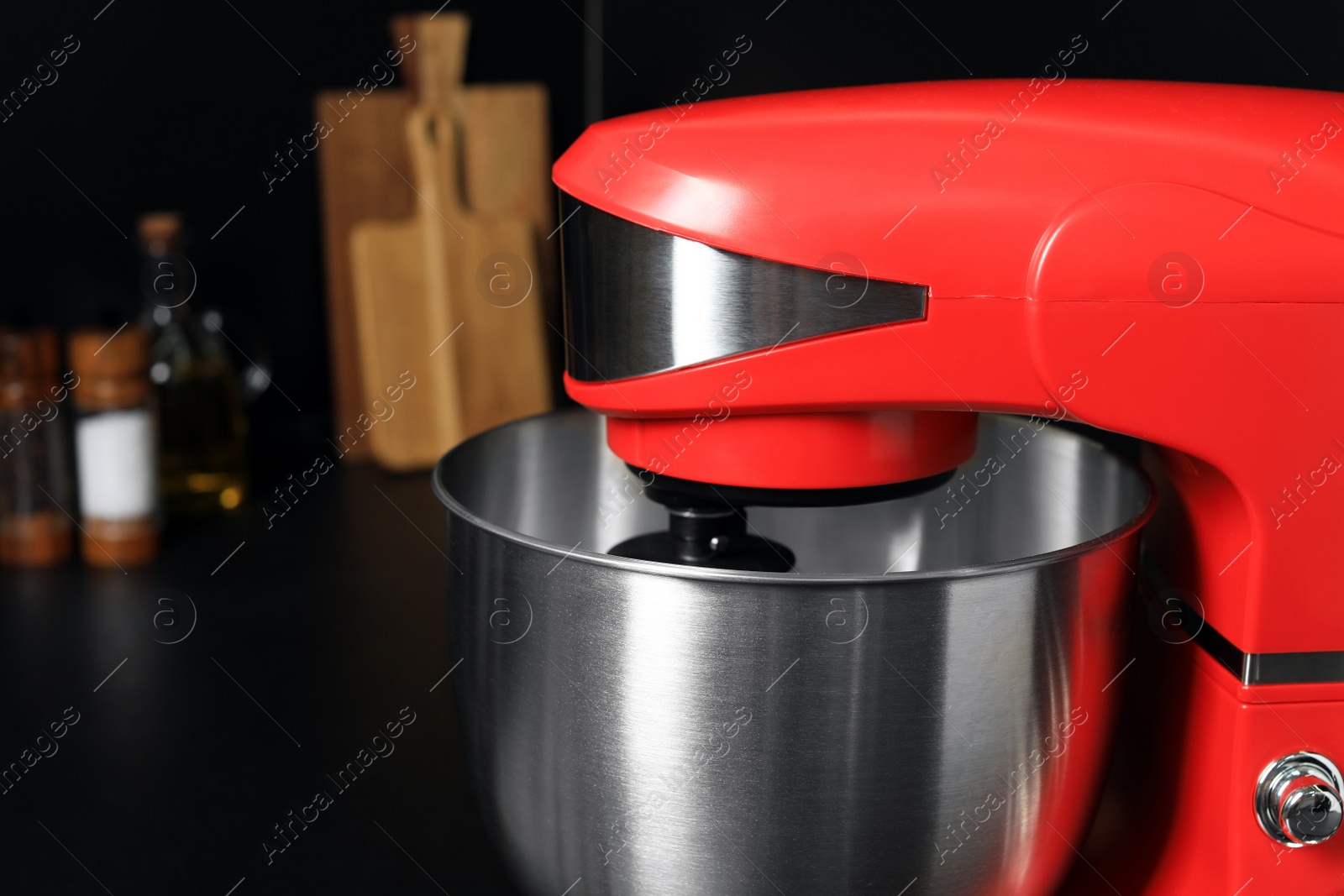 Photo of Modern red stand mixer on countertop in kitchen, closeup