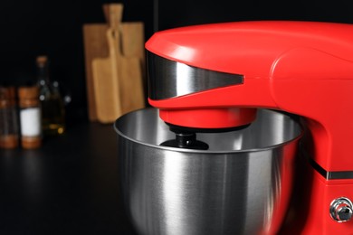 Modern red stand mixer on countertop in kitchen, closeup