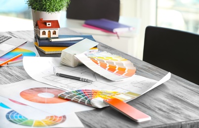 Photo of Color palette samples and house plan on table