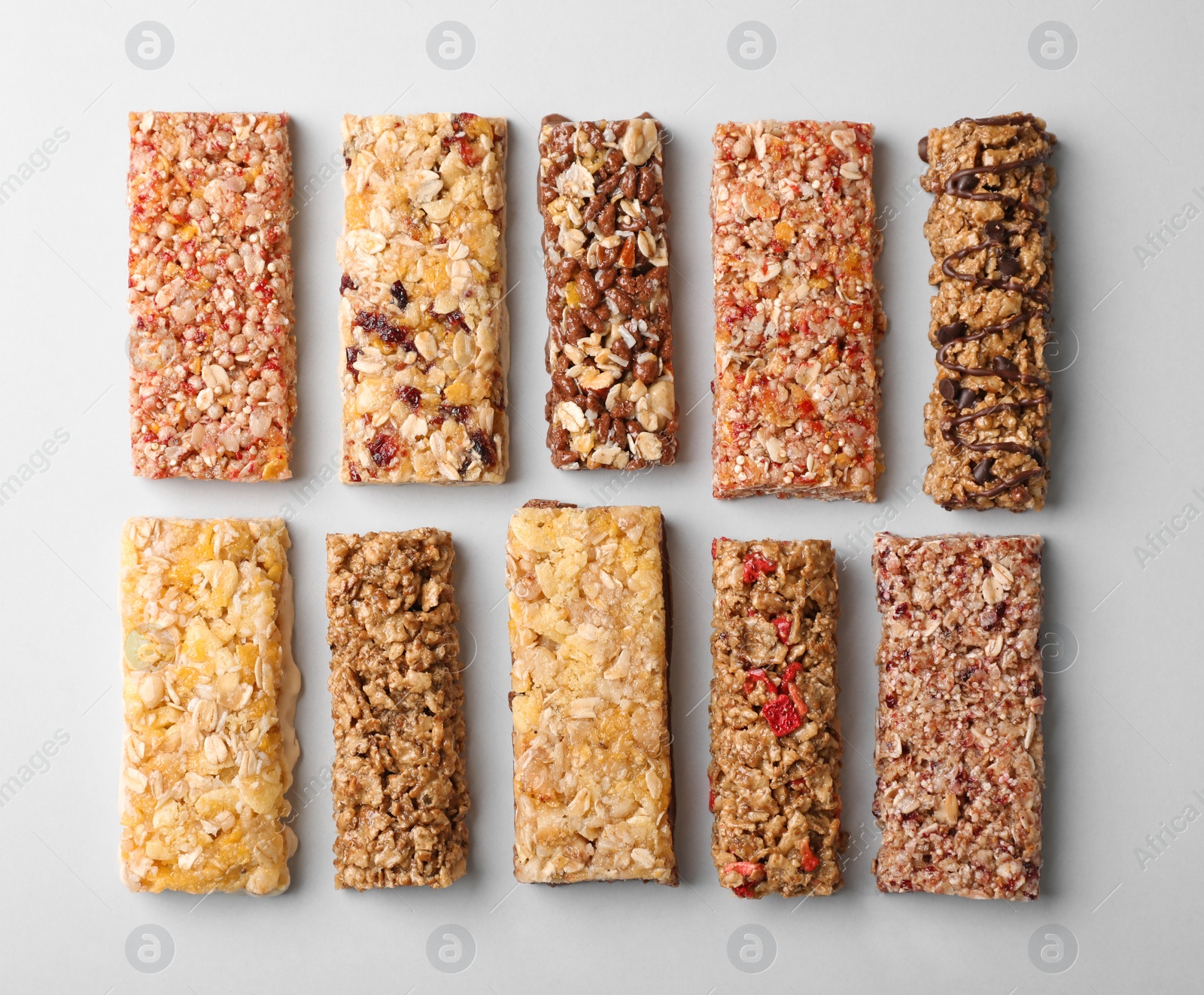 Photo of Flat lay composition with protein bars on grey background