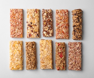 Photo of Flat lay composition with protein bars on grey background