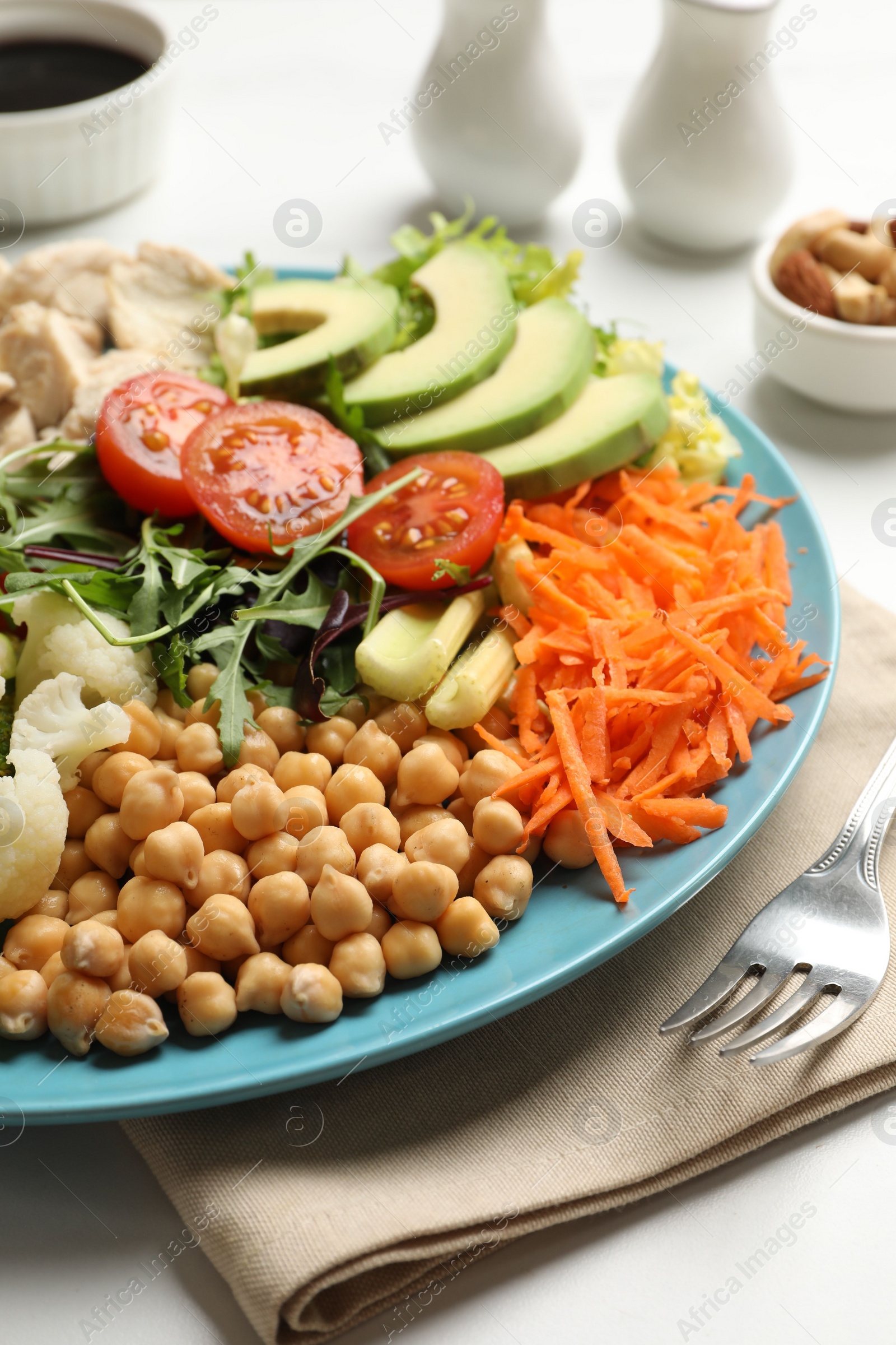 Photo of Balanced diet and healthy foods. Plate with different delicious products on white marble table, closeup