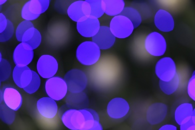 Photo of Blurred view of glowing Christmas lights as background. Festive mood