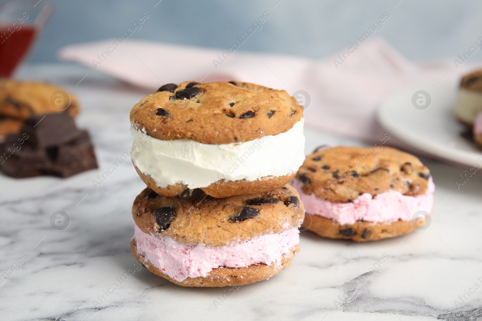 Photo of Sweet delicious ice cream cookie sandwiches on table