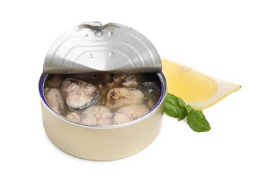 Photo of Open tin can with mackerel chunks, lemon and basil on white background