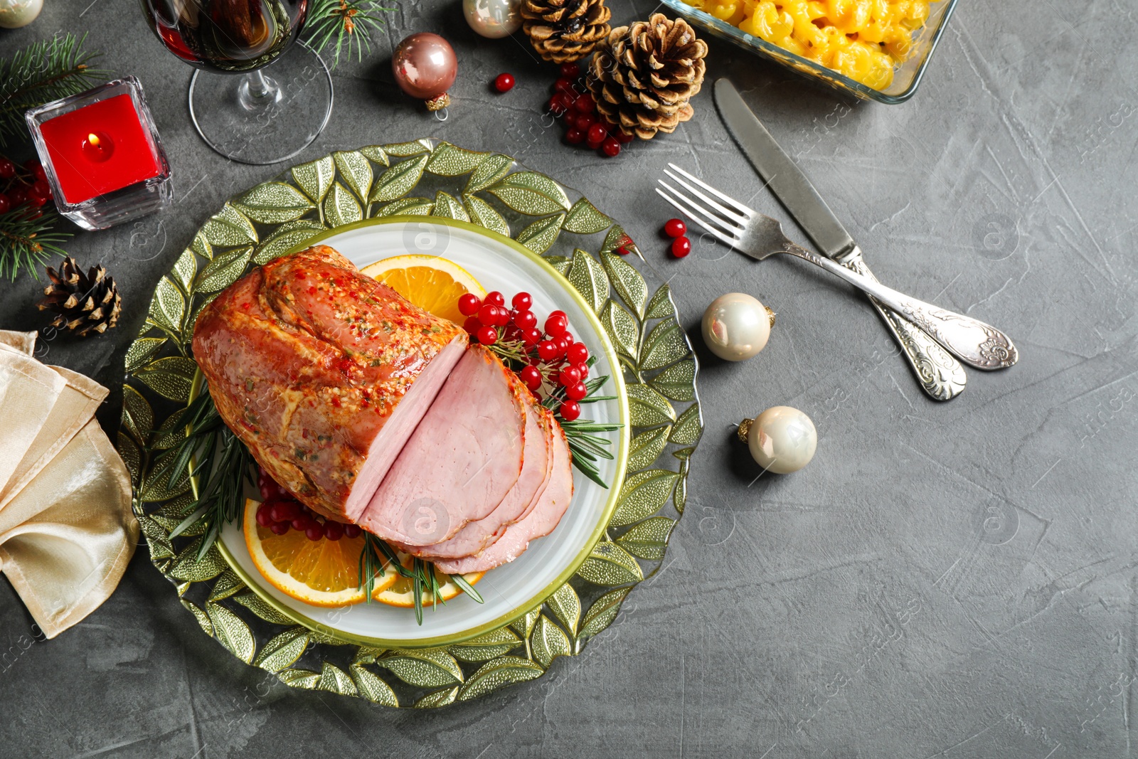 Photo of Flat lay composition with delicious ham served on grey table. Christmas dinner