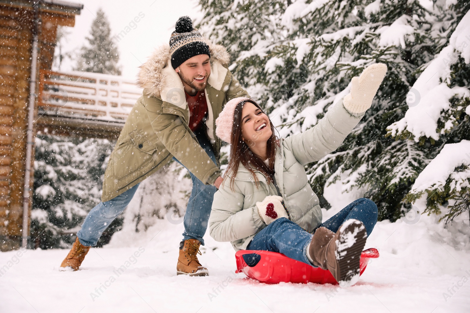 Photo of Happy couple having fun together outdoors on snowy day. Winter vacation