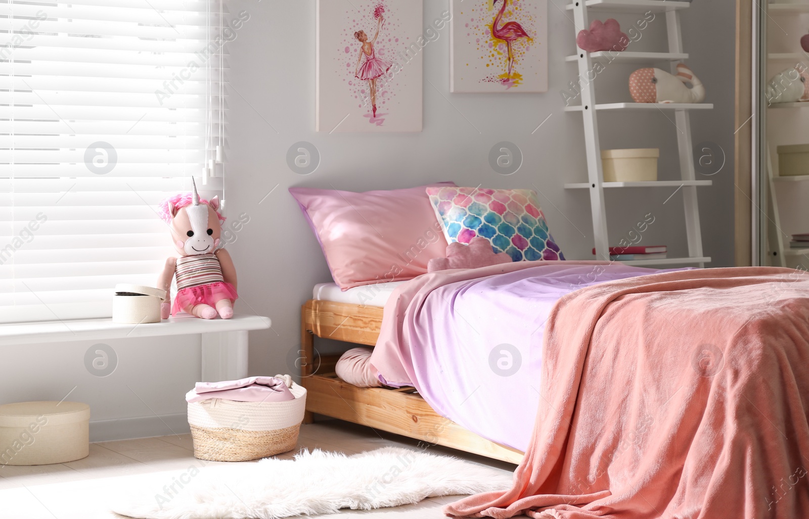 Photo of Bed with beautiful linens in children's room. Modern interior design