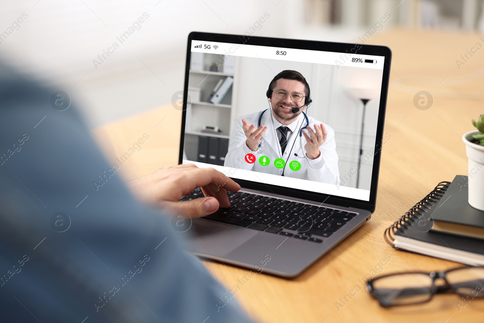 Image of Online medical consultation. Man having video chat with doctor via laptop at table indoors, closeup