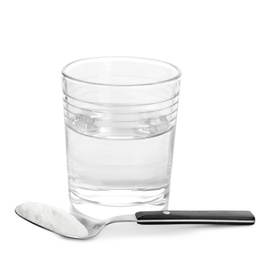 Glass of water and spoon with baking soda on white background