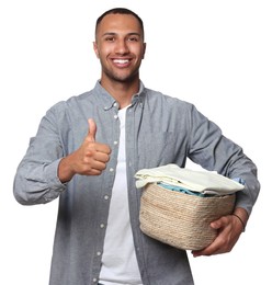 Photo of Happy man with basket full of laundry showing thumb up on white background