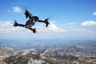 Image of Modern drone flying over picturesque mountains. Aerial survey