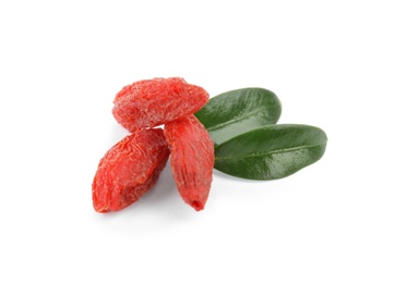 Photo of Dried goji berries and leaves on white background