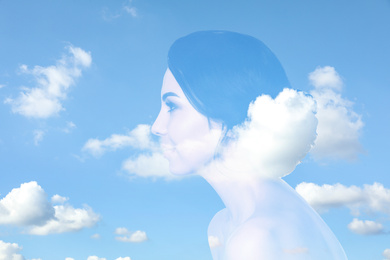 Double exposure of beautiful woman and blue sky. Concept of inner power