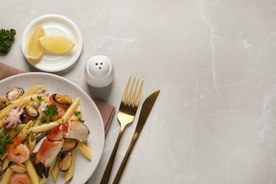 Delicious pasta with sea food served on light grey table, flat lay. Space for text