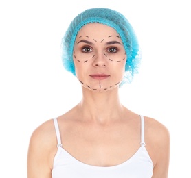 Photo of Portrait of woman with marks on face for cosmetic surgery operation against white background