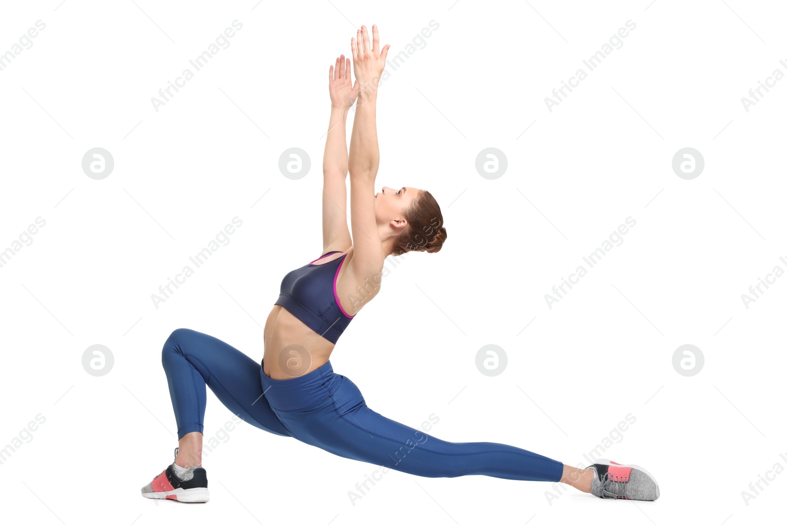 Photo of Yoga workout. Young woman stretching on white background