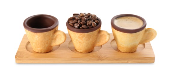 Photo of Edible biscuit cups with espresso, coffee beans and empty one on white background