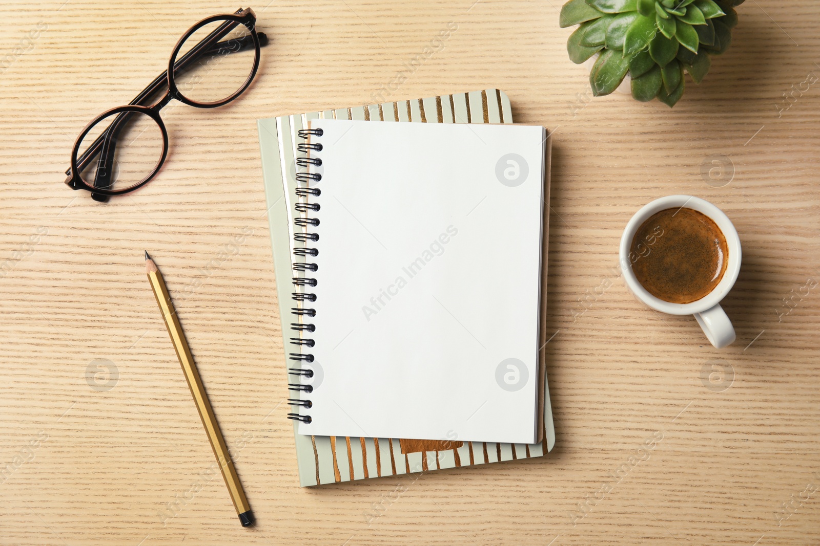 Photo of Flat lay composition with notebooks, coffee and glasses on wooden background