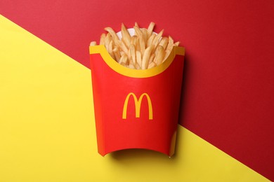Photo of MYKOLAIV, UKRAINE - AUGUST 12, 2021: Big portion of McDonald's French fries on color background, top view