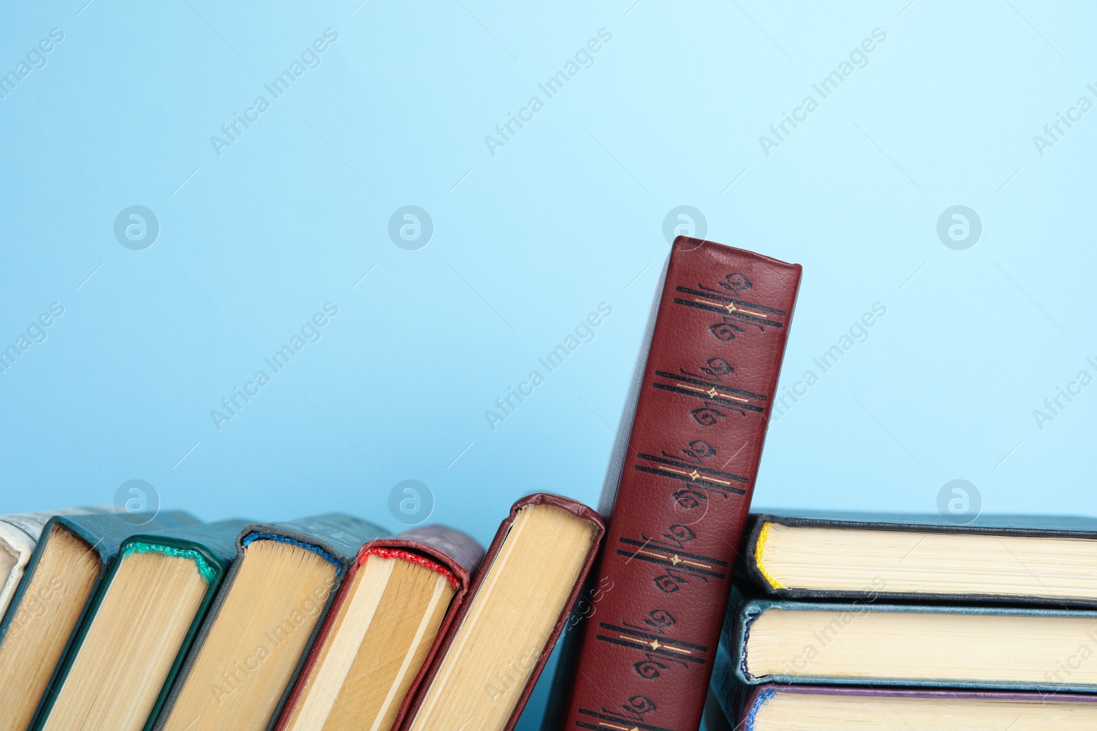 Photo of Collection of old books on light blue background