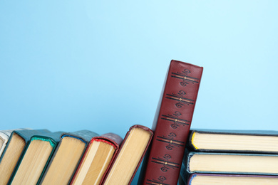 Collection of old books on light blue background