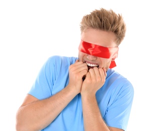 Photo of Scared young man wearing red blindfold on white background
