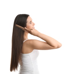 Photo of Beautiful young woman with hair comb on white background