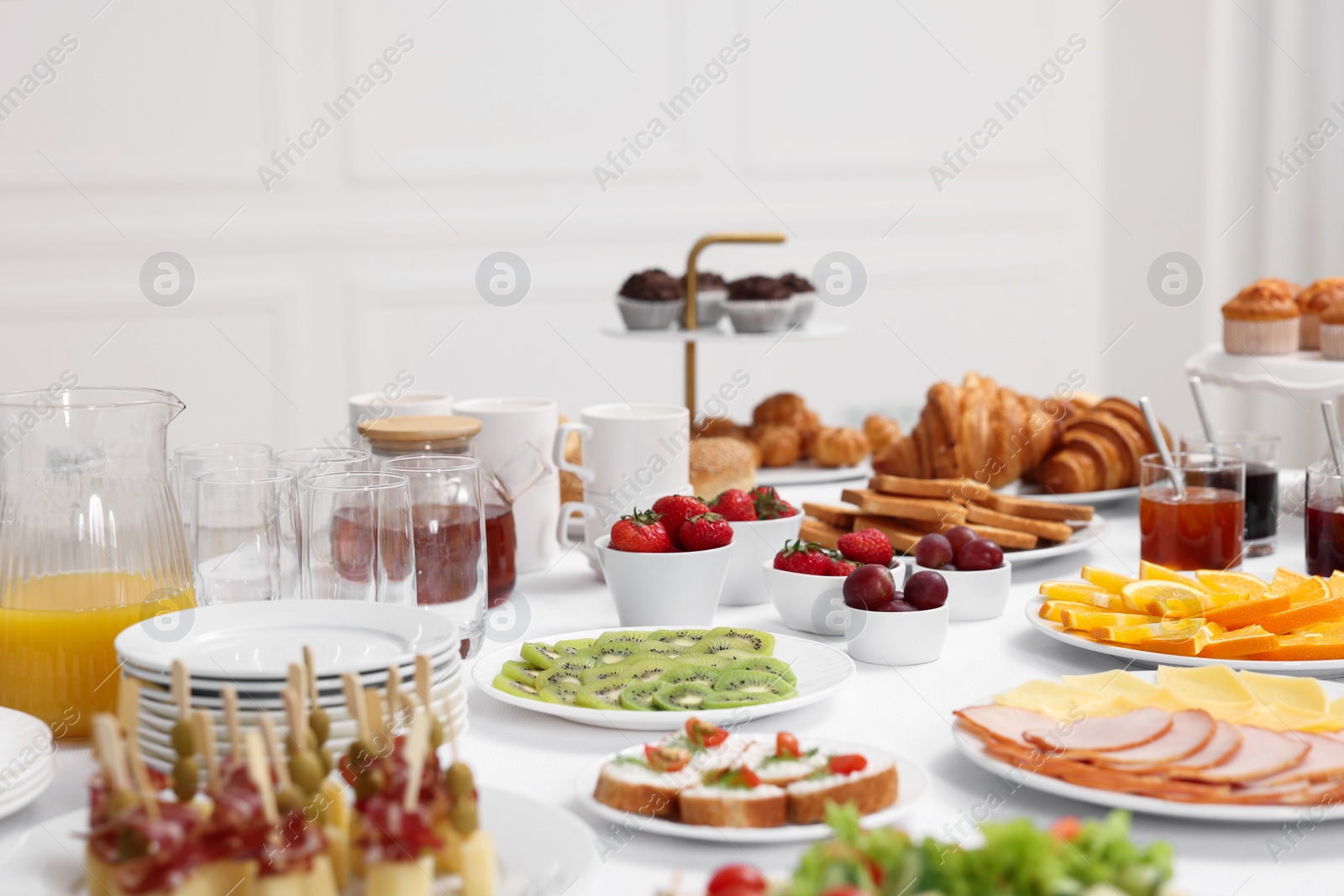 Photo of Different meals served on white table indoors, selective focus. Buffet menu