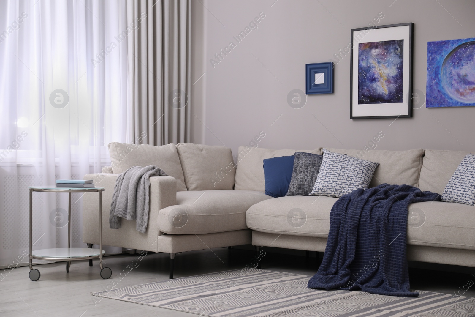 Photo of Comfortable sofa in stylish living room interior