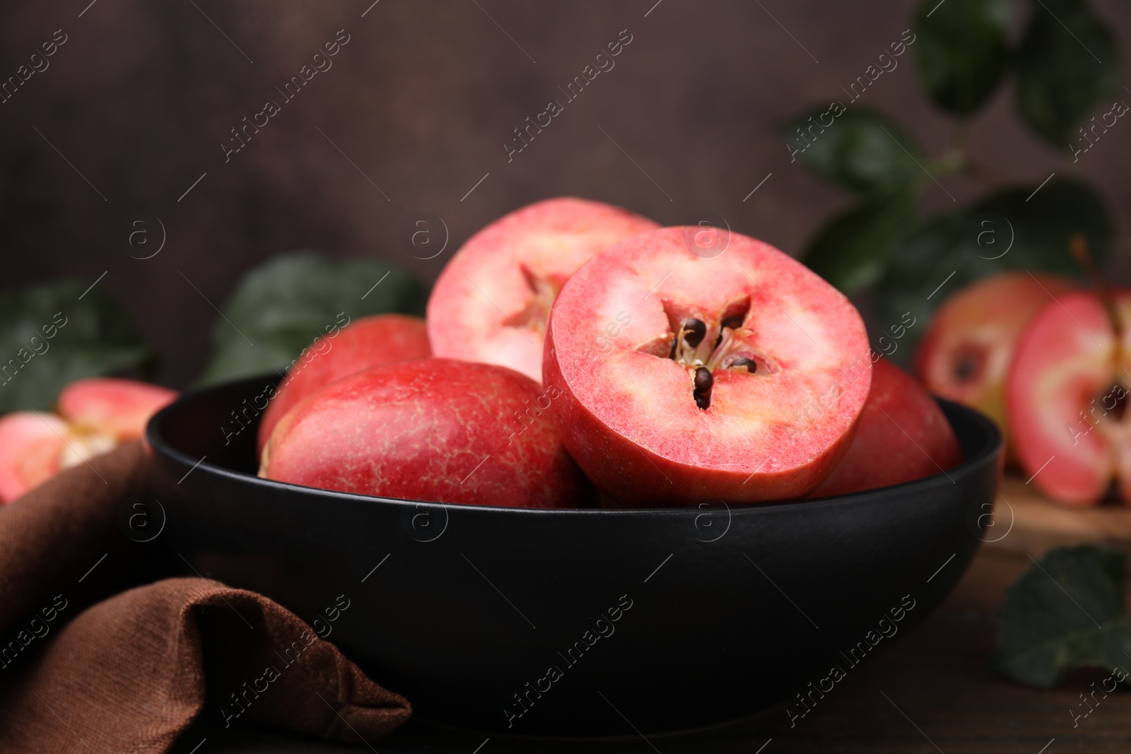 Photo of Tasty apples with red pulp on wooden table, closeup