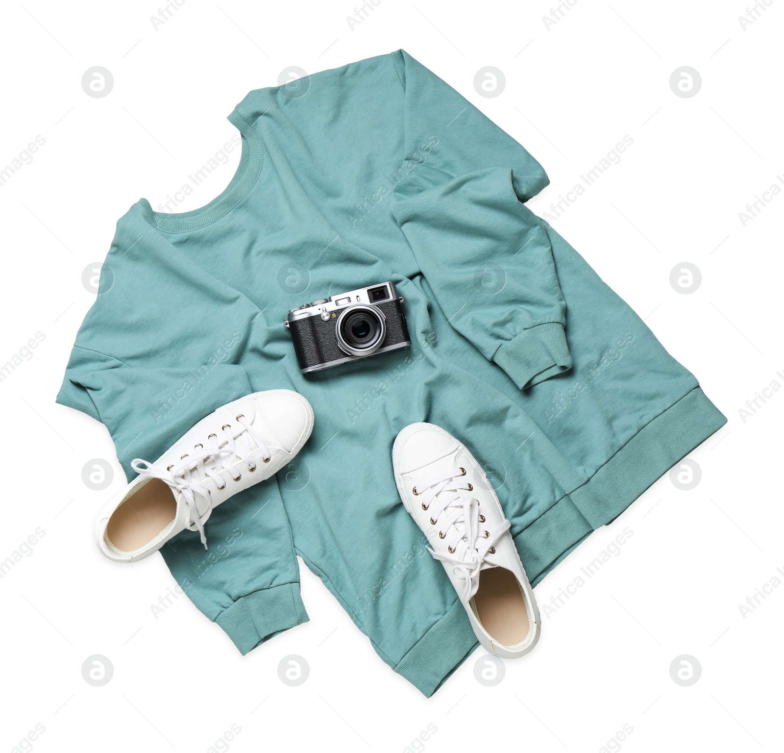 Photo of Sweater, shoes and camera on light background, flat lay