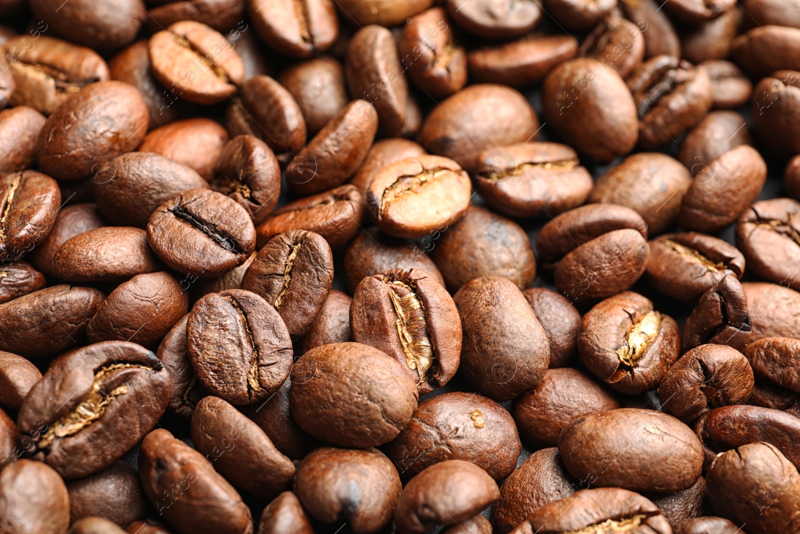 Photo of Pile of roasted coffee beans as background, closeup